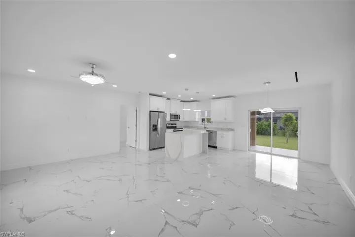 Unfurnished living room with recessed lighting and light marble finish flooring
