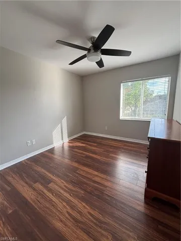 Unfurnished room with dark wood-style floors