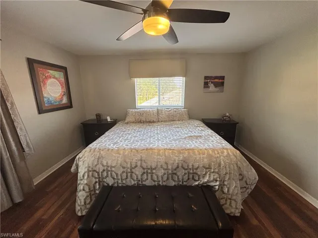 Bedroom with dark wood-style flooring and ceiling fan