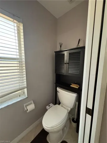 Bathroom featuring light tile patterned floors and toilet
