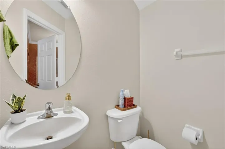 Bathroom featuring a sink and a textured wall