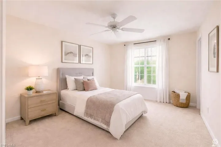 Bedroom featuring light-toned carpeting, a window with blinds and sheer curtains, and a ceiling fan