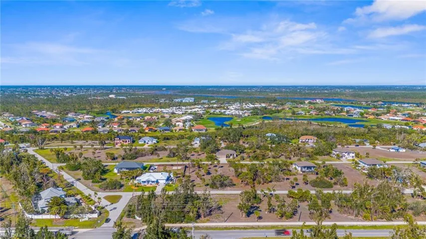 View of property location featuring a nearby body of water and nearby suburban area