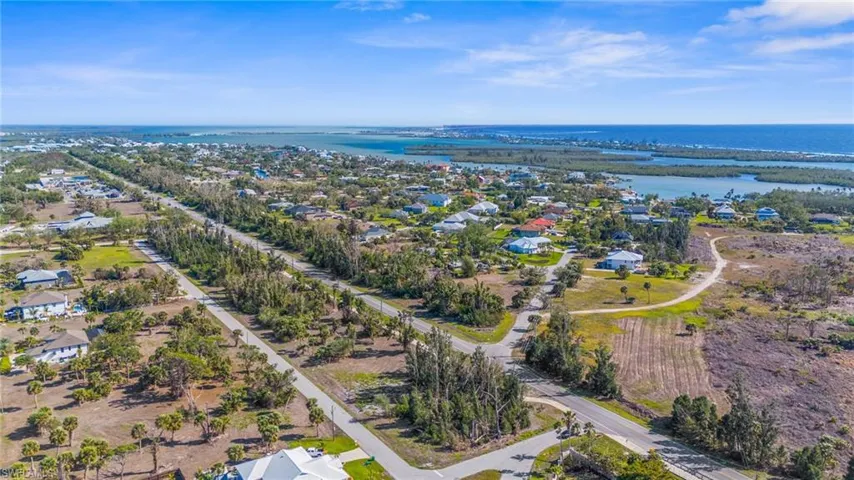 Aerial perspective of suburban area featuring a large body of water