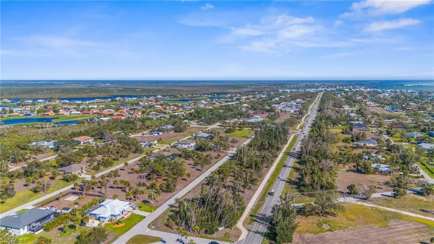 Aerial perspective of suburban area featuring a large body of water