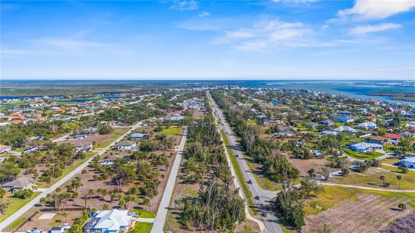 Aerial perspective of suburban area with a nearby body of water