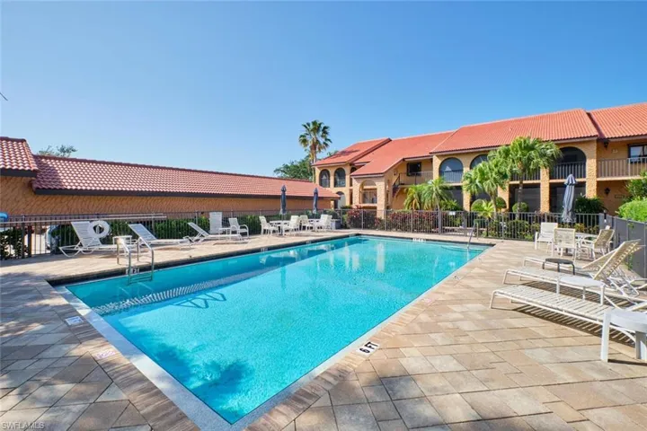 Community pool with a patio