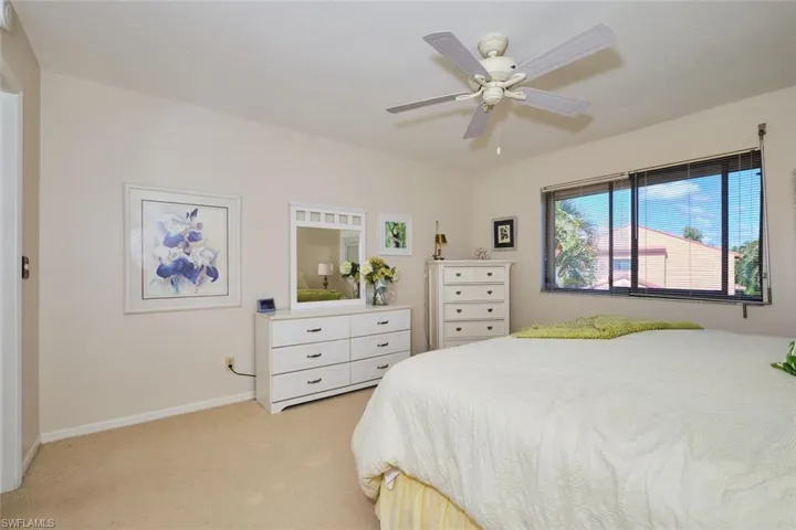 Bedroom with light carpet and ceiling fan