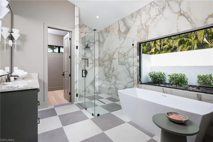 Bathroom featuring vanity and plus walk in shower