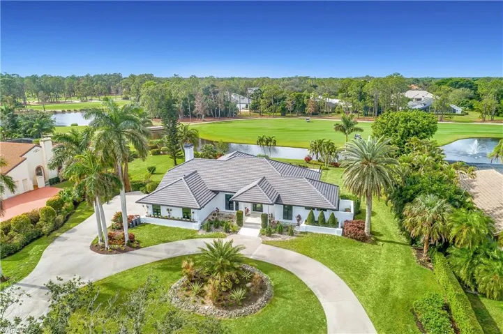 Aerial view featuring golf course view and a water view