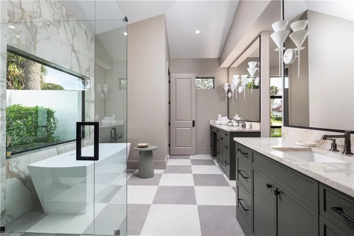 Bathroom with vanity, vaulted ceiling, and independent shower and bath
