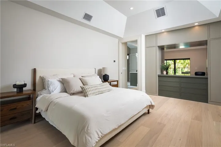 Bedroom featuring wood-type flooring and lofted ceiling