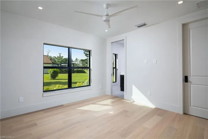 Empty room with ceiling fan and light wood-type flooring