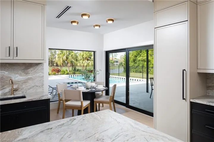 Dining space with light hardwood / wood-style floors and sink