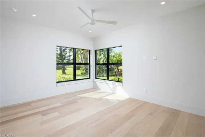 Empty room with light hardwood / wood-style flooring and ceiling fan