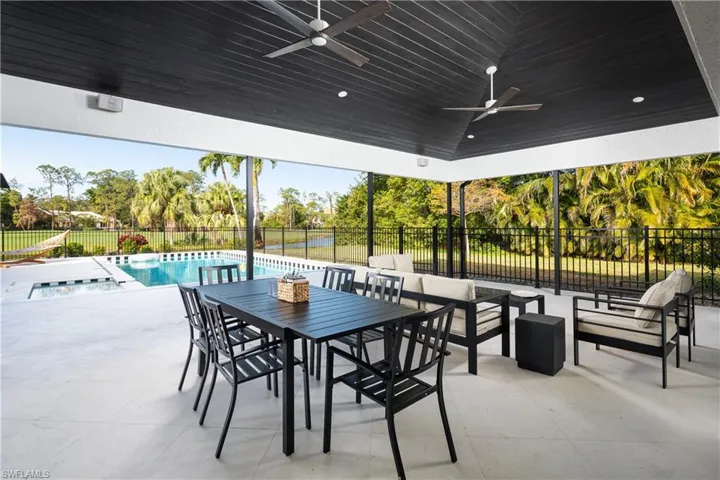 View of patio with outdoor lounge area, a swimming pool with hot tub, and ceiling fan