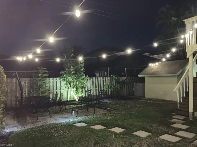 Yard at night featuring a patio area
