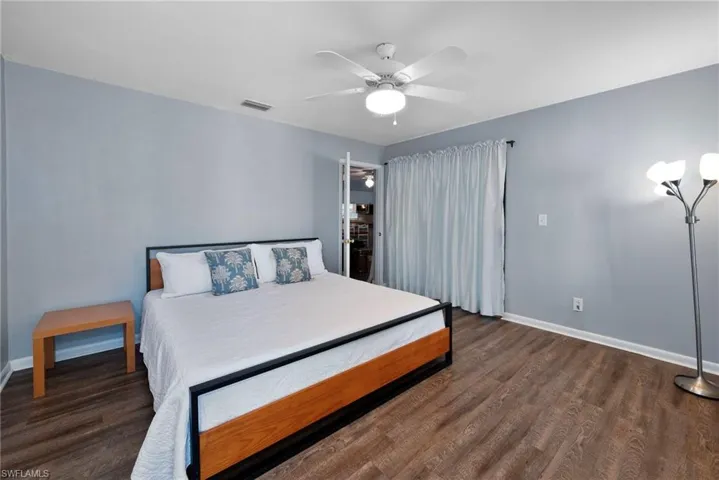 Bedroom featuring dark hardwood / wood-style floors and ceiling fan