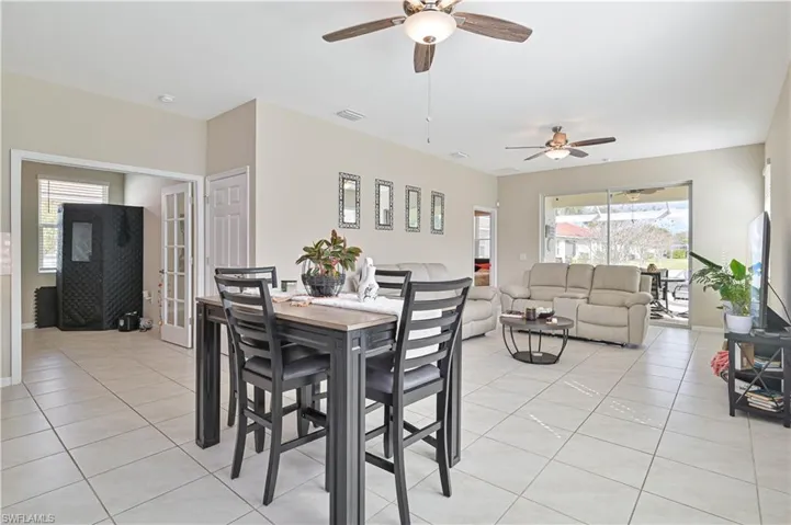 Dining area featuring light tile patterned flooring and ceiling fan