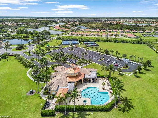 Aerial view of residential area with a large body of water and a pool