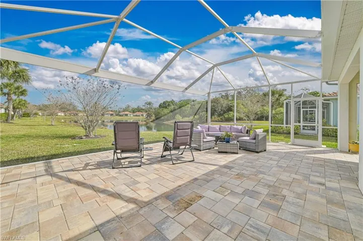 View of patio / terrace with a lanai, a sunroom, a water view, and an outdoor hangout area