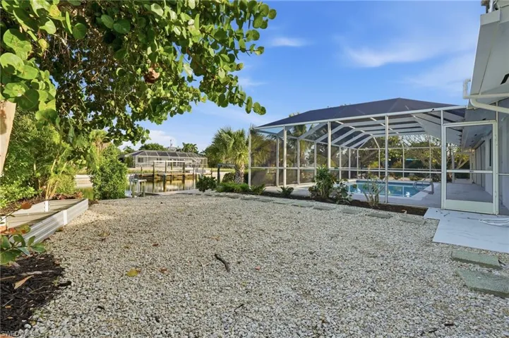 Screened pool enclosure featuring a concrete deck and a private swimming pool