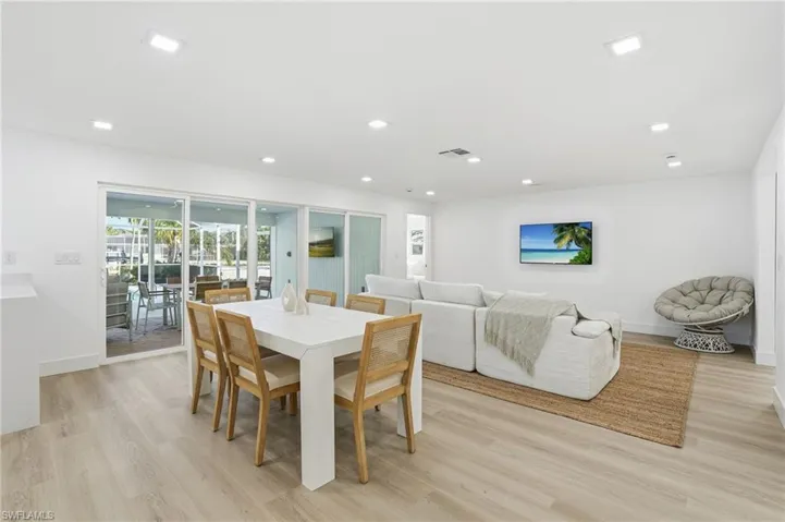 Open-concept living area featuring light wood-finish flooring and recessed lighting