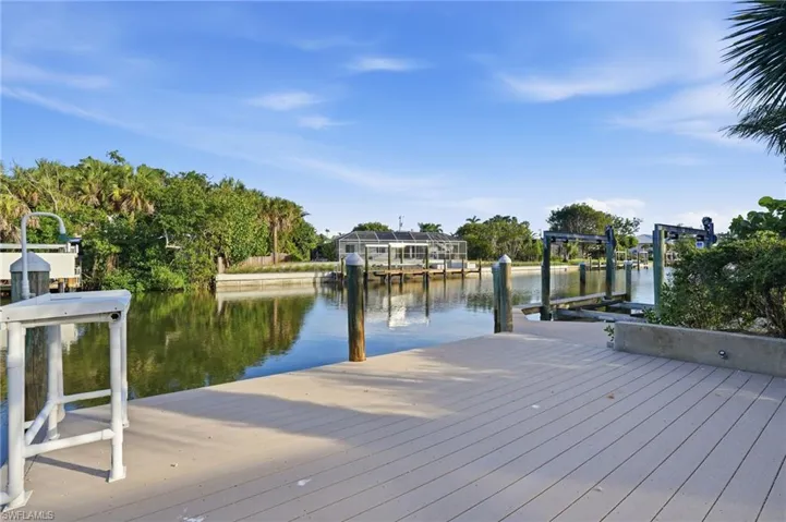 Expansive waterfront dock with composite decking and multiple boat lifts