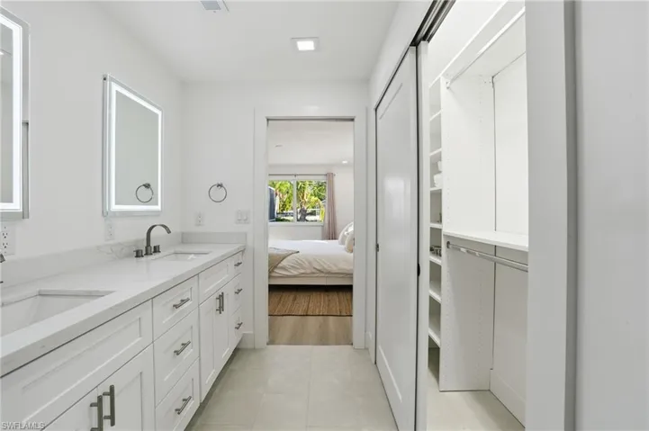 Bathroom vanity with dual sinks, quartz countertop, and matte black fixtures