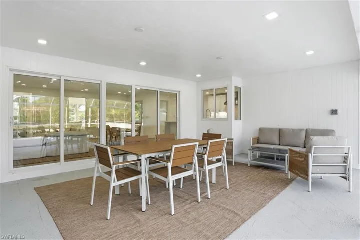 Covered patio featuring recessed lighting, a sliding glass door system, and a corner window detail