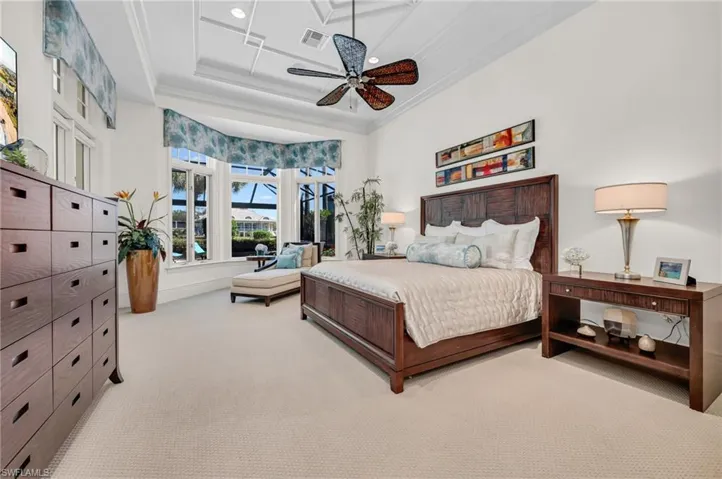 The Primary Suite is oversized and has a sitting area, with tranquil views over the lake, golf course, and the Estuary Clubhouse.