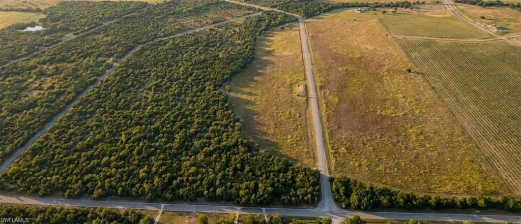 Expansive acreage featuring a mix of mature tree coverage and open fields