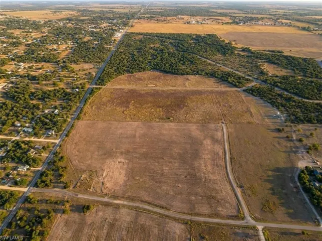 Expansive undeveloped land featuring large, open fields and natural tree lines