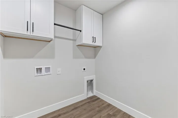 Laundry with upper cabinets.