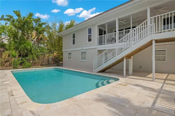View of swimming pool featuring ceiling fan and a patio area