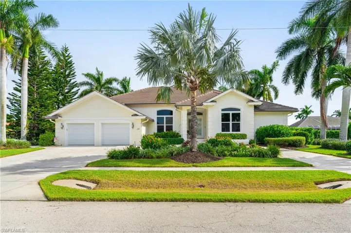 View of front facade with a front yard and a garage