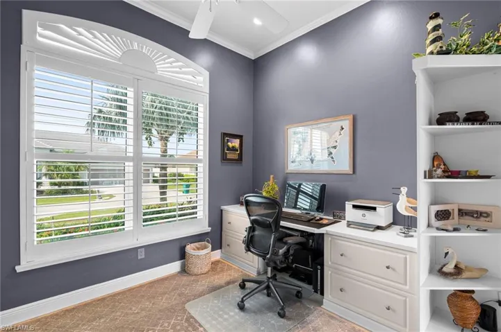 Home office with crown molding and ceiling fan