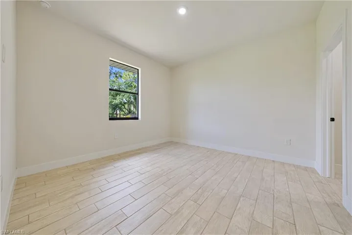 Unfurnished room with light wood-type flooring and baseboards
