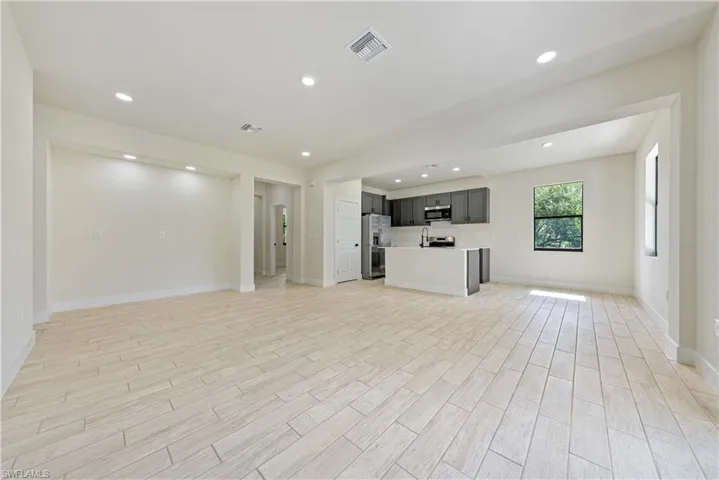 Unfurnished living room featuring light wood-style flooring and recessed lighting