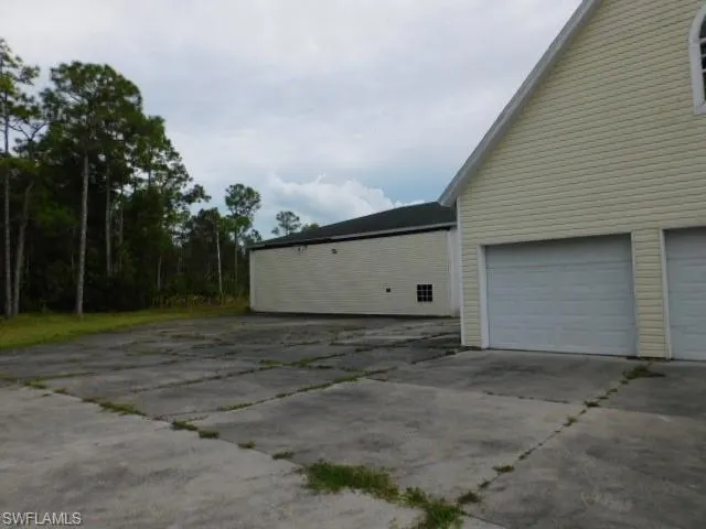 Garage featuring concrete driveway