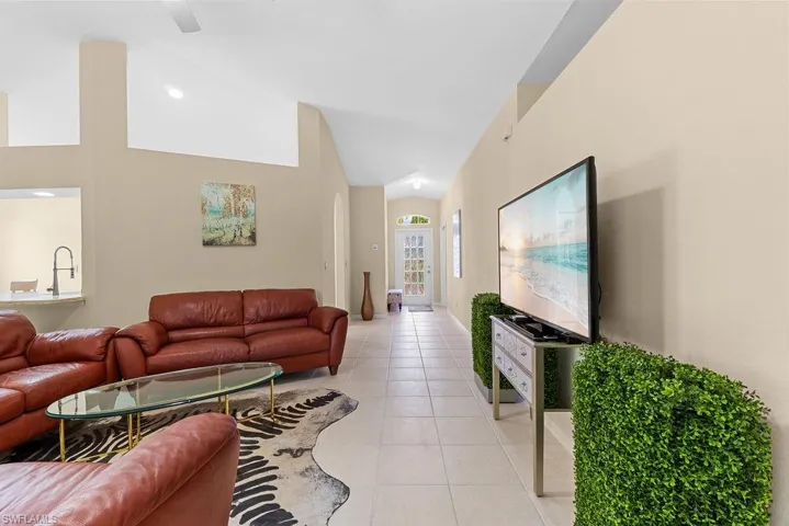 Vaulted ceilings, tile flooring, and recessed lighting