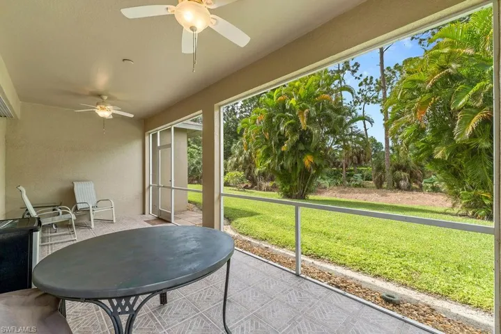 Screened patio with ceiling fans, tile flooring, and direct access to the outdoor area