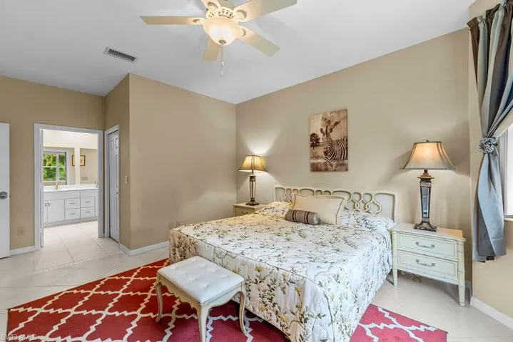 Recessed lighting, ceiling fan, tile flooring, and an adjoining room with a dual vanity