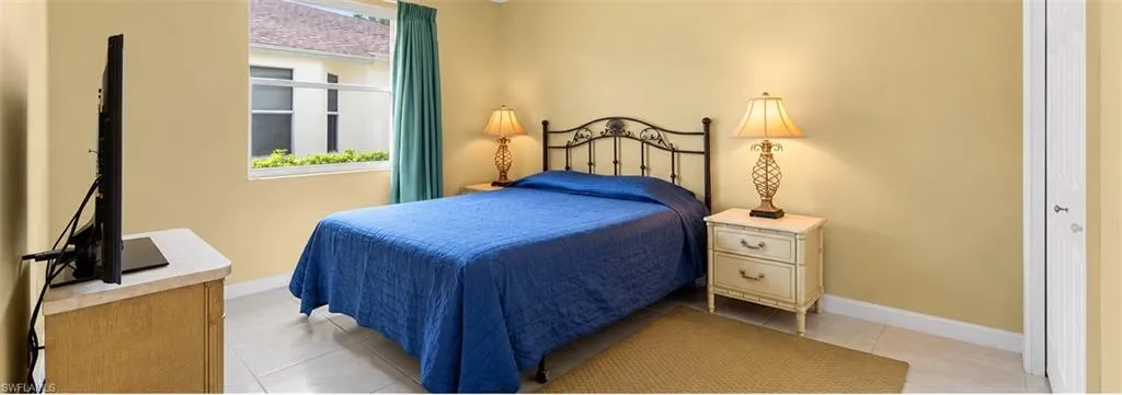 Neutral-toned interior space featuring light-colored tile flooring and a double-hung window