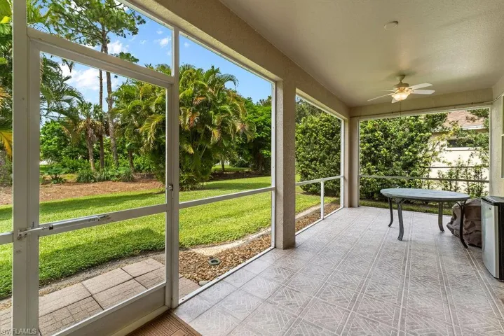 Screened lanai featuring a ceiling fan, recessed lighting, and patterned tile flooring