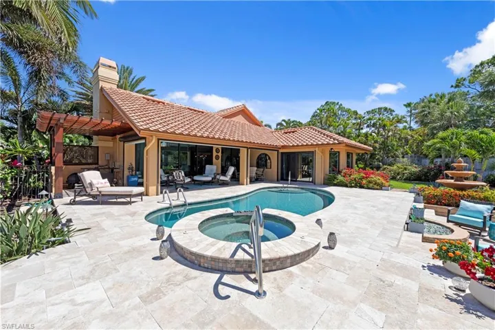 View of pool featuring a patio, a pool with spa and firepit area
