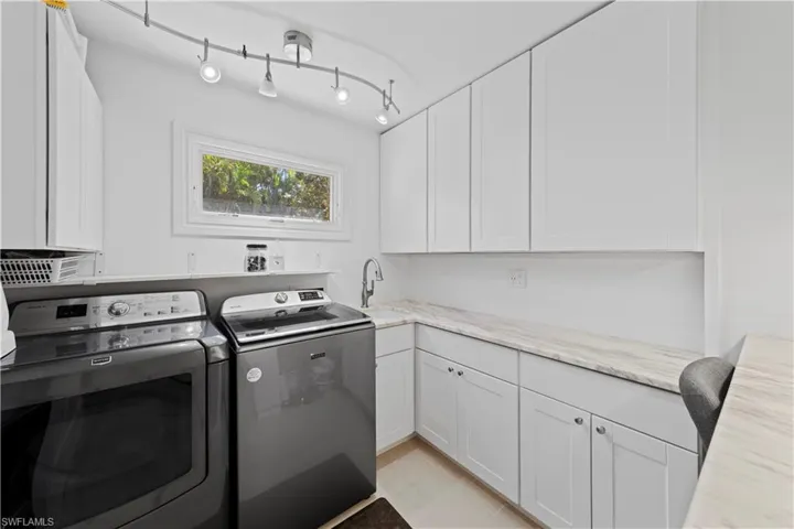 Laundry room with washer and dryer, sink and cabinet space
