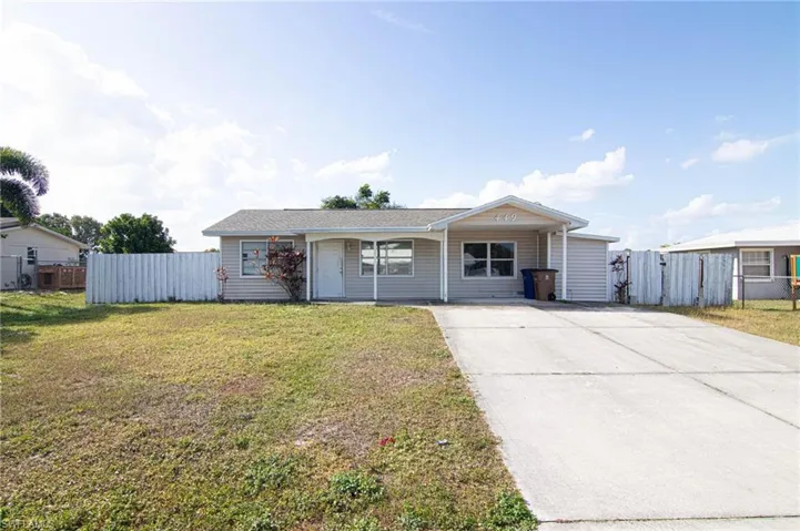 Ranch-style house with concrete driveway