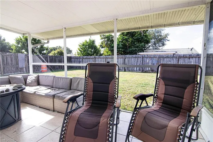 Fenced backyard with a patio area and an outdoor hangout area