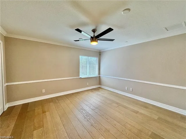 Hardwood-finish flooring throughout, complemented by crown molding and chair rail detailing